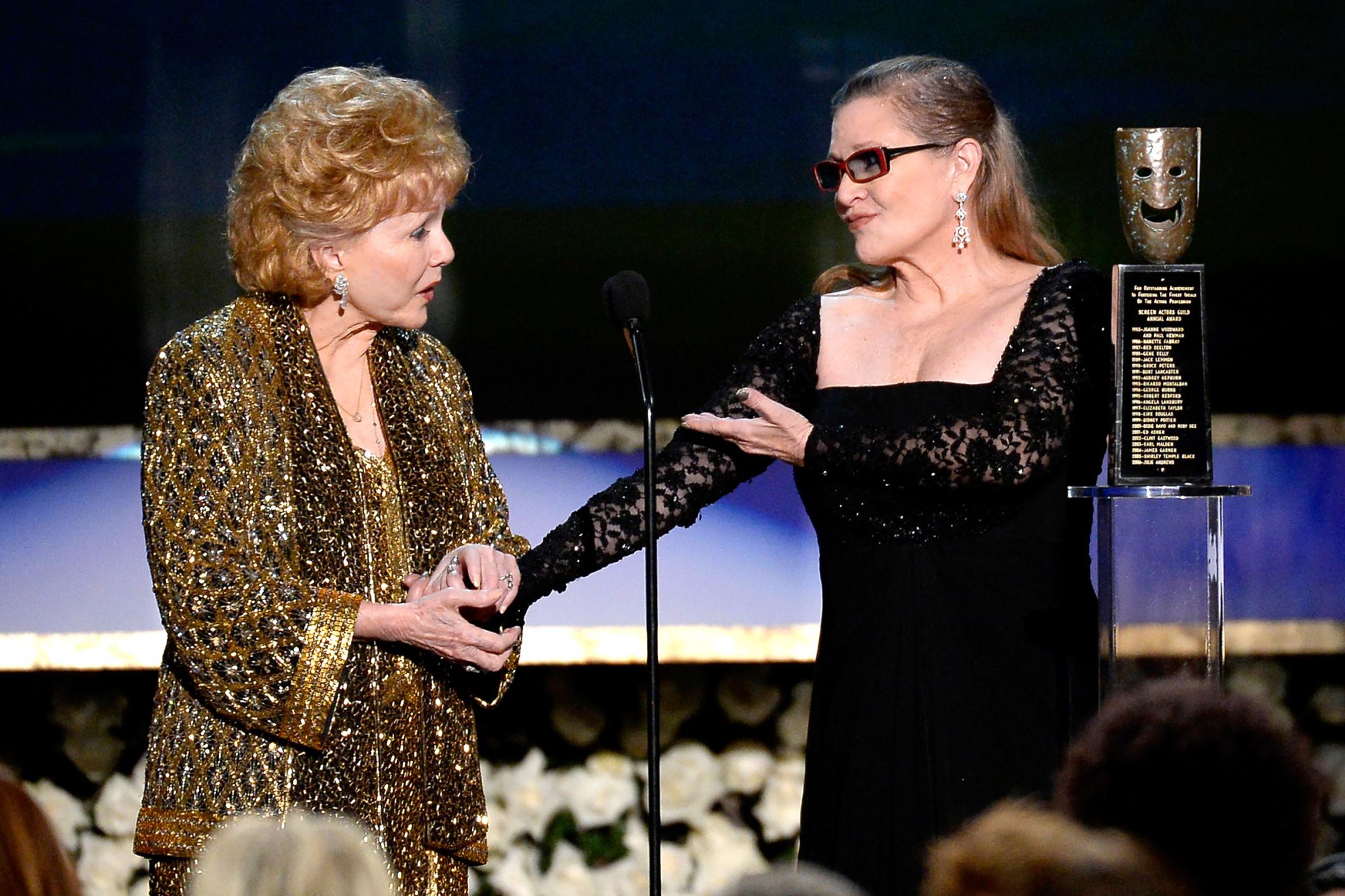 LOS ANGELES, CA - JANUARY 25: Actress Debbie Reynolds (L) accepts the Life Achievement Award from actress Carrie Fisher onstage at the 21st Annual Screen Actors Guild Awards at The Shrine Auditorium on January 25, 2015 in Los Angeles, California. (Photo by Kevork Djansezian/Getty Images)